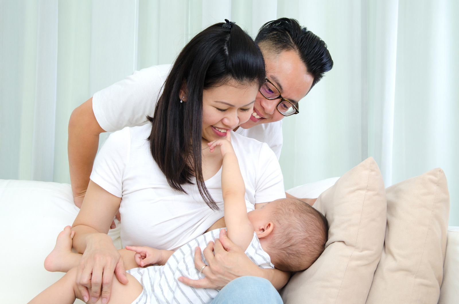 Indoor portrait of asian mother breastfeeding her baby