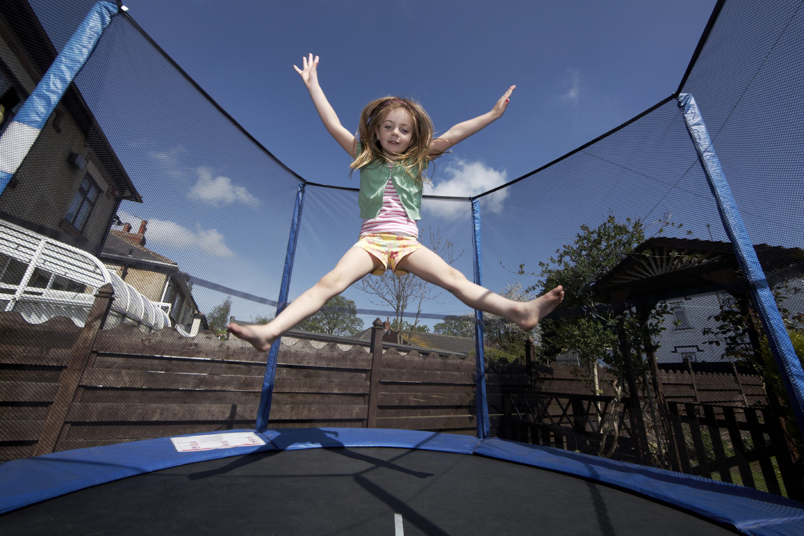 girl playing in trampoline