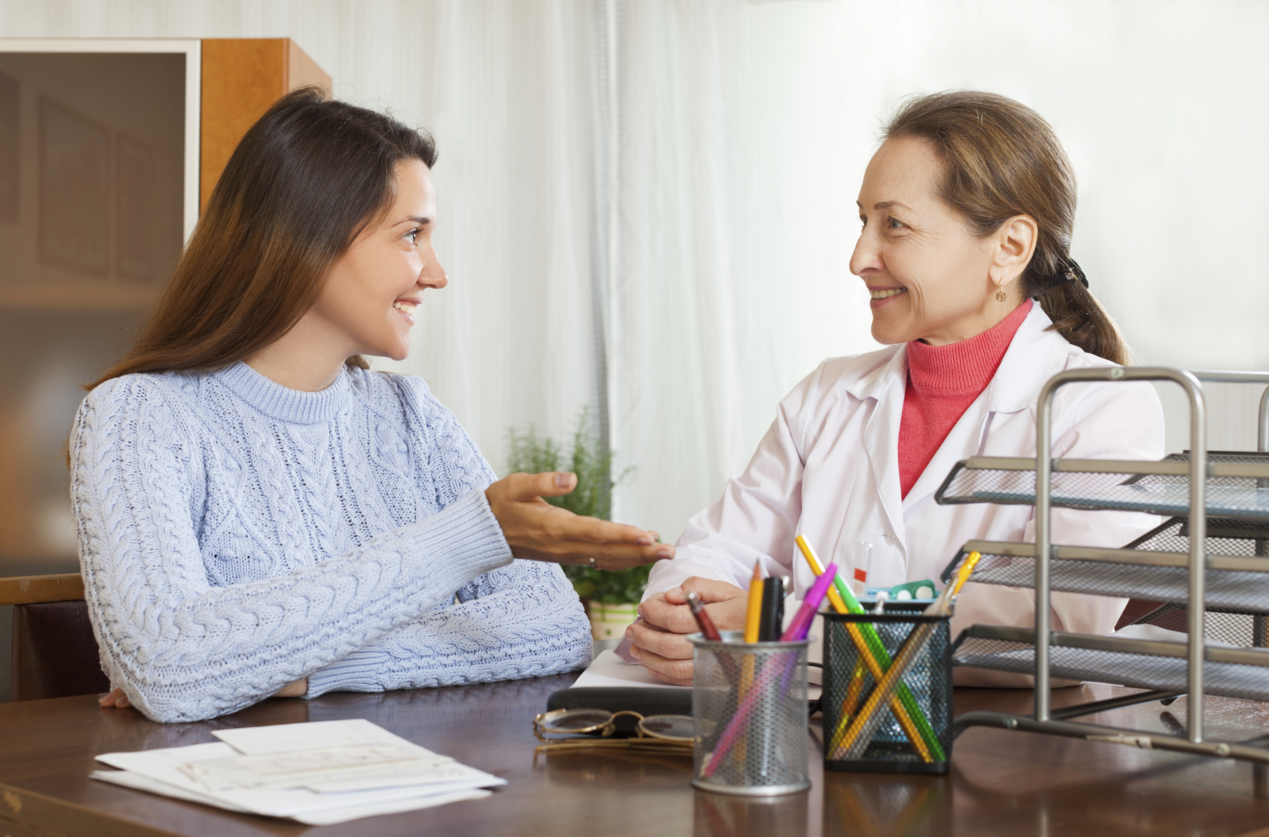 Female doctor and teenage girl patient