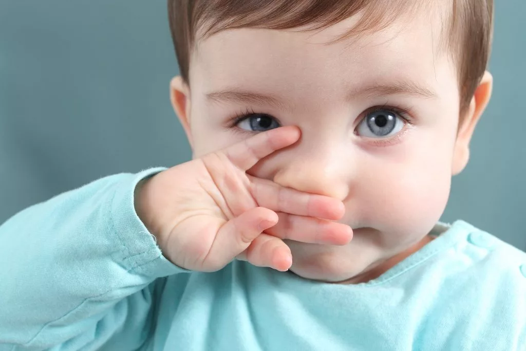 Baby rubbing sales nose and crying